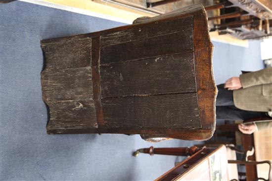 An 18th century boarded oak framed armchair,
